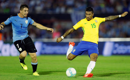 Football Soccer - Uruguay v Brazil - World Cup 2018 Qualifiers - Centenario stadium, Montevideo, Uruguay - 23/3/17 - Brazil's Paulinho (R) scores his first goal next to Uruguay's Cristian Rodriguez. REUTERS/Andres Stapff