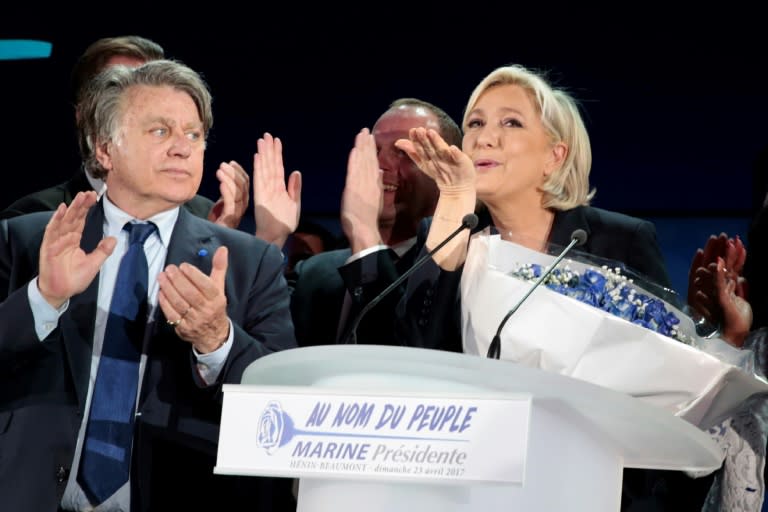 French far-right leader Marine Le Pen celebrates after projections show she has got through to the second round of the presidential election