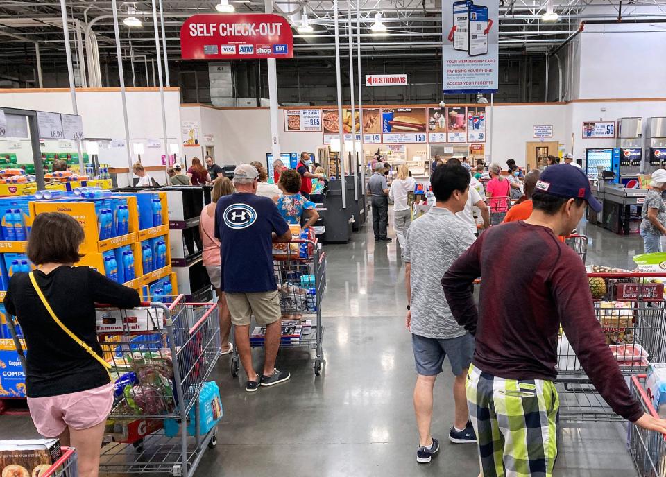 Shoppers wait in a check-out line at a Costco wholesale store in Orlando.