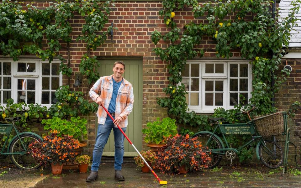 Tom Brown using a wire brush to kill weeds