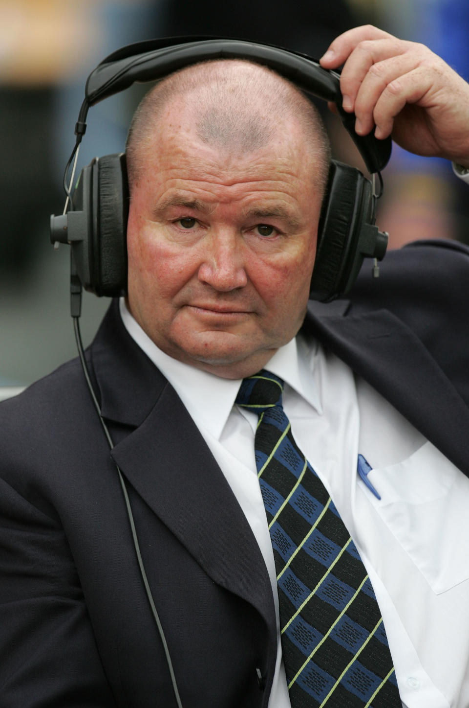 Former Kiwi coach and now commentator Graham Lowe adjusts his headset.