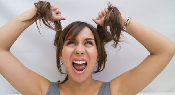 Close-up of a woman pulling her hair