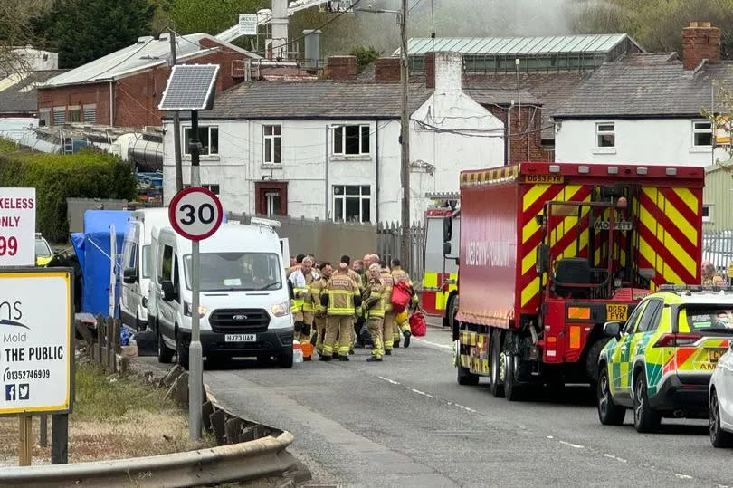 A unit command centre is set up in the shadow of the factory fire at Mold