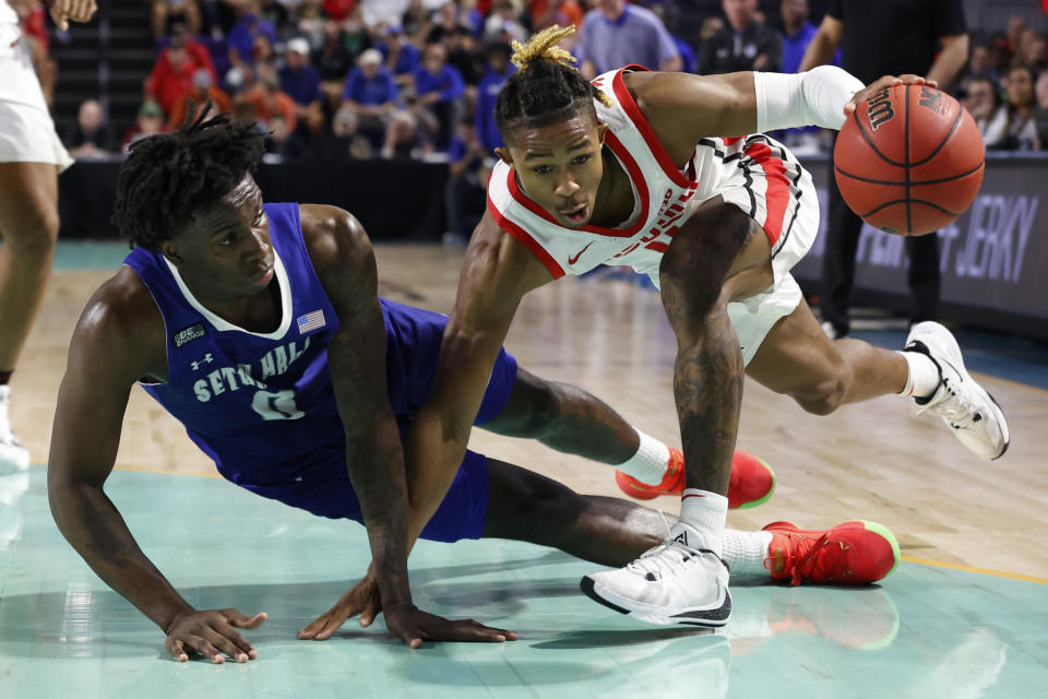 Seton Hall guard Kadary Richmond, left, falls to court after fouling Ohio State guard Meechie Johnson Jr. during the second half of an NCAA college basketball game Monday, Nov. 22, 2021, in Fort Myers, Fla. (AP Photo/Scott Audette)