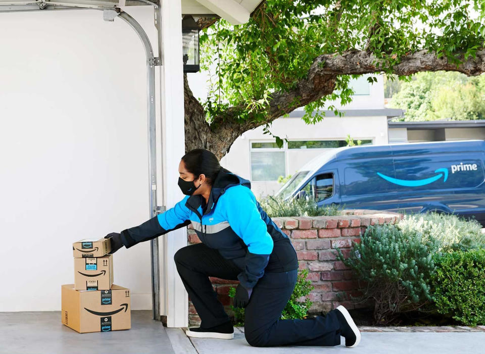 Delivery driver stacking boxes in a garage