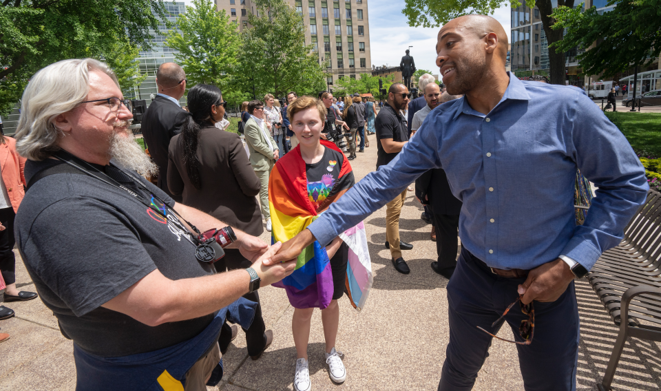 Lt. Gov. Mandela Barnes, right, greets people at the Rainbow Pride flag raising Wednesday, June 1, 2022 at the Capitol in Madison, Wis. The symbol of lesbian, gay, bisexual and transgender pride will be flown over the Capitol’s East Wing in recognition of LGBTQ Pride Month, which runs until the end of June. In June 2019, Gov. Tony Evers issued an executive order to raise the pride flag above the state Capitol for the first time in Wisconsin history. This is the fourth year the flag has flown below the U.S. and state flags on the east-wing flagpole.