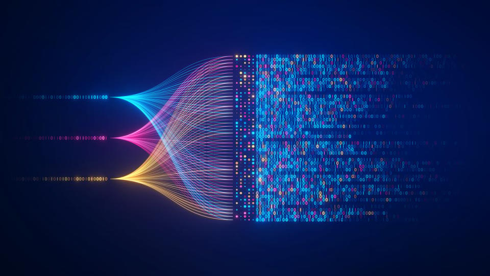 Display of binary code in different colors that come together in flowing patterns and lines. 