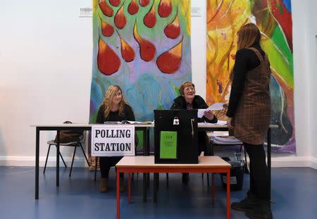 A woman receives her ballot paper in a polling station at St Anthonys School in Castlebar, Ireland February 26, 2016. REUTERS/Clodagh Kilcoyne