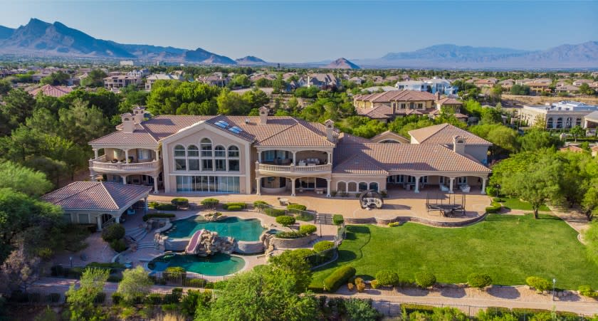 The 20,000-square-foot residence includes 10 bedrooms, 11 bathrooms, a movie theater, billiards room, elevator and indoor basketball court.