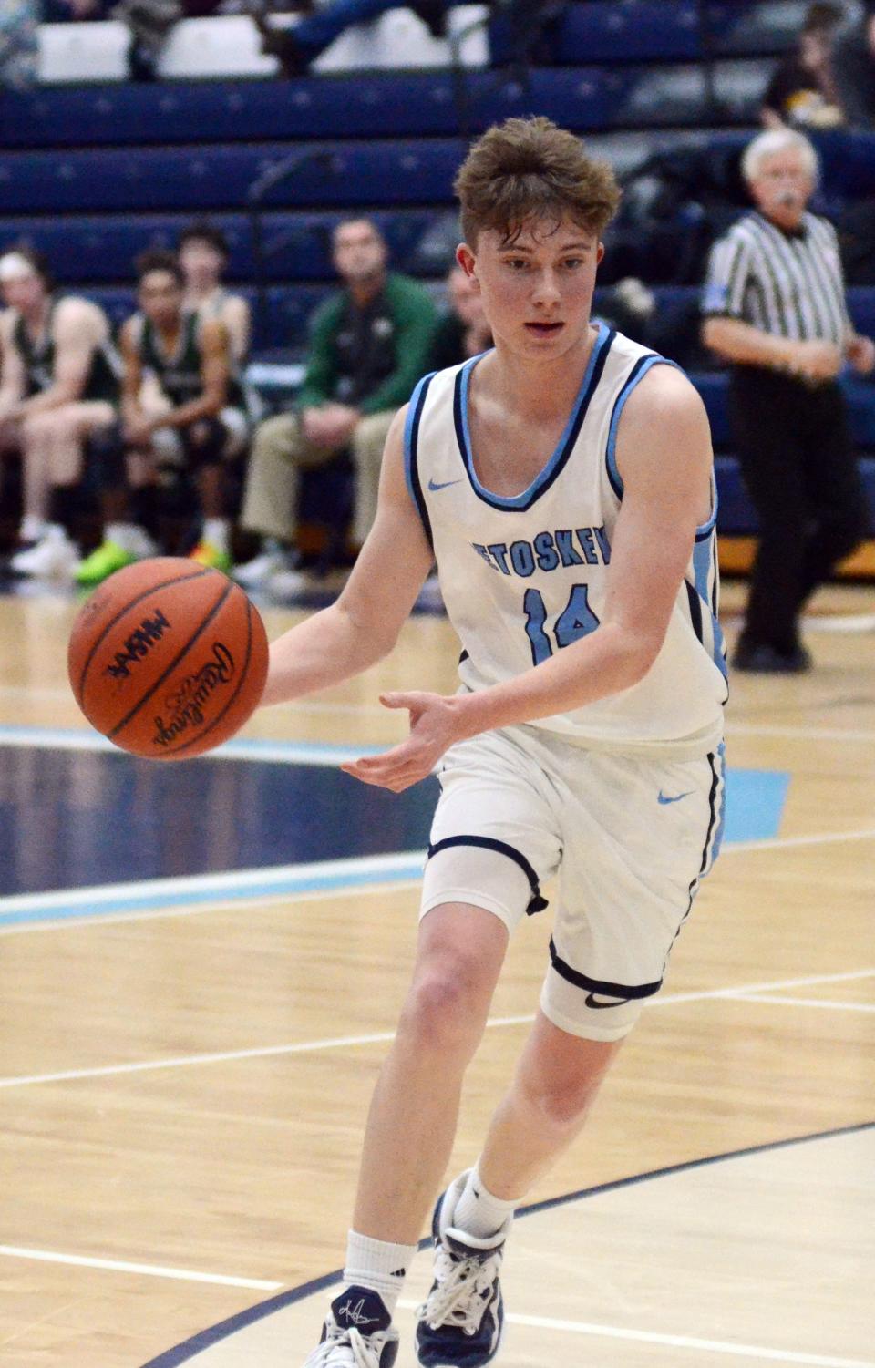 Dylan Odenbach of Petoskey drives and dishes to a teammate during the second half Friday.