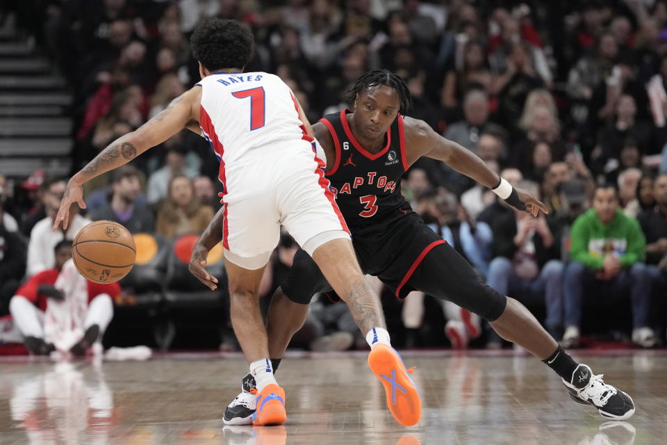Detroit Pistons guard Killian Hayes (7) and Toronto Raptors forward O.G. Anunoby (3) vie for the ball during the first half of an NBA basketball game Friday, March 24, 2023, in Toronto. (Frank Gunn/The Canadian Press via AP)