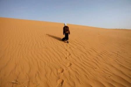 A girl walks near Ouled Said ksar, a fortified village on the outskirts of the Sahara oasis town of Timimoun, Algeria, in this March 24, 2008 file photo. REUTERS/Zohra Bensemra/Files