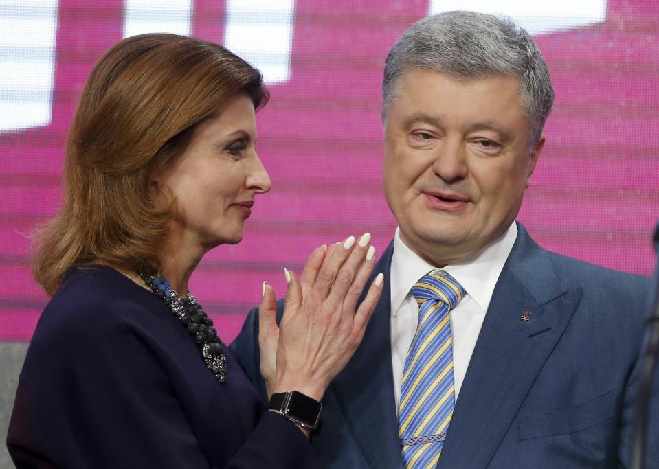 Ukrainian President Petro Poroshenko's wife Maryna stands with her husband at his headquarters after the second round of presidential elections in Kiev, Ukraine, Sunday, April 21, 2019. Ukrainian President Petro Poroshenko is accepting defeat in the election for the country's top post. (AP Photo/Efrem Lukatsky)