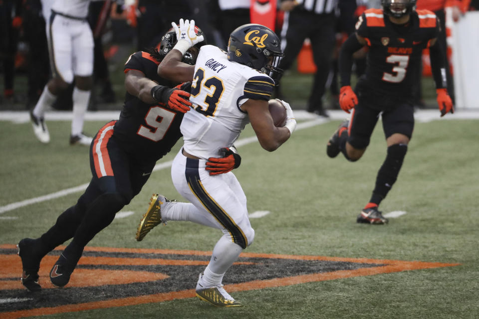California running back Marcel Dancy (23) is brought down by Oregon State outside linebacker Hamilcar Rashed Jr. during the second half of an NCAA college football game in Corvallis, Ore., Saturday, Nov. 21, 2020. Oregon State won 31-27. (AP Photo/Amanda Loman)
