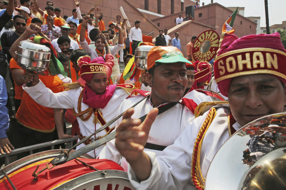 A brass band celebrates with Bharatiya Janata Party (BJP) supporters in New Delhi, India, Thursday, May 23, 2019. Indian Prime Minister Narendra Modi's party claimed it had won reelection with a commanding lead in Thursday's vote count, while the stock market soared in anticipation of another five-year term for the pro-business Hindu nationalist leader. (AP Photo/Manish Swarup)