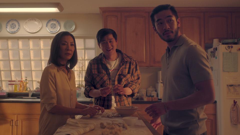 This image released by Netflix shows Michelle Yeoh as Mama Sun, Sam Song Li as Bruce Sun, and Justin Chien as Charles Sun in an episode of "The Brothers Sun." (Netflix via AP)