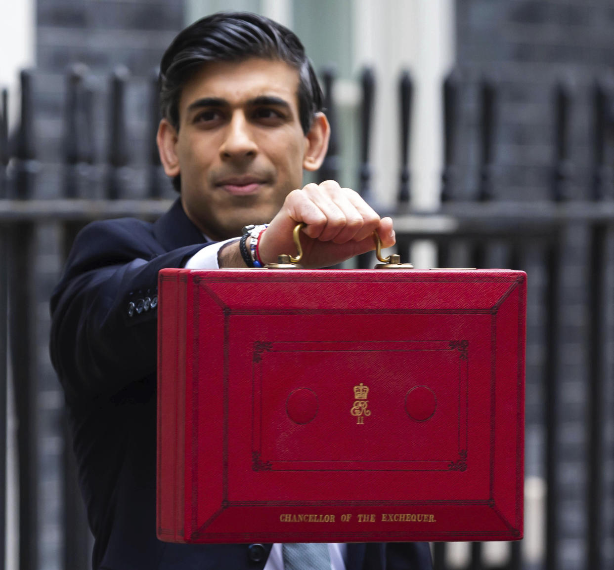 Photo by: zz/KGC-254/STAR MAX/IPx 2021 3/3/21 Chancellor of the Exchequer Rishi Sunak displays the red budget briefcase to waiting media on Downing Street on March 3, 2021. When he delivers his budget to Parliament, The Chancellor is expected to announce billions of pounds in tax cuts and spending increases and maintain numerous other support packages to assist workers, businesses and all citizens as the worldwide coronavirus pandemic continues. (London, England, UK)