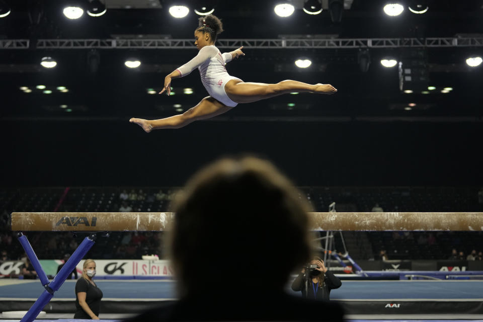 A judge watches as Jordan Chiles performs her balance-beam routine during the U.S. Classic gymnastics meet in Indianapolis, Saturday, May 22, 2021. (AP Photo/AJ Mast)