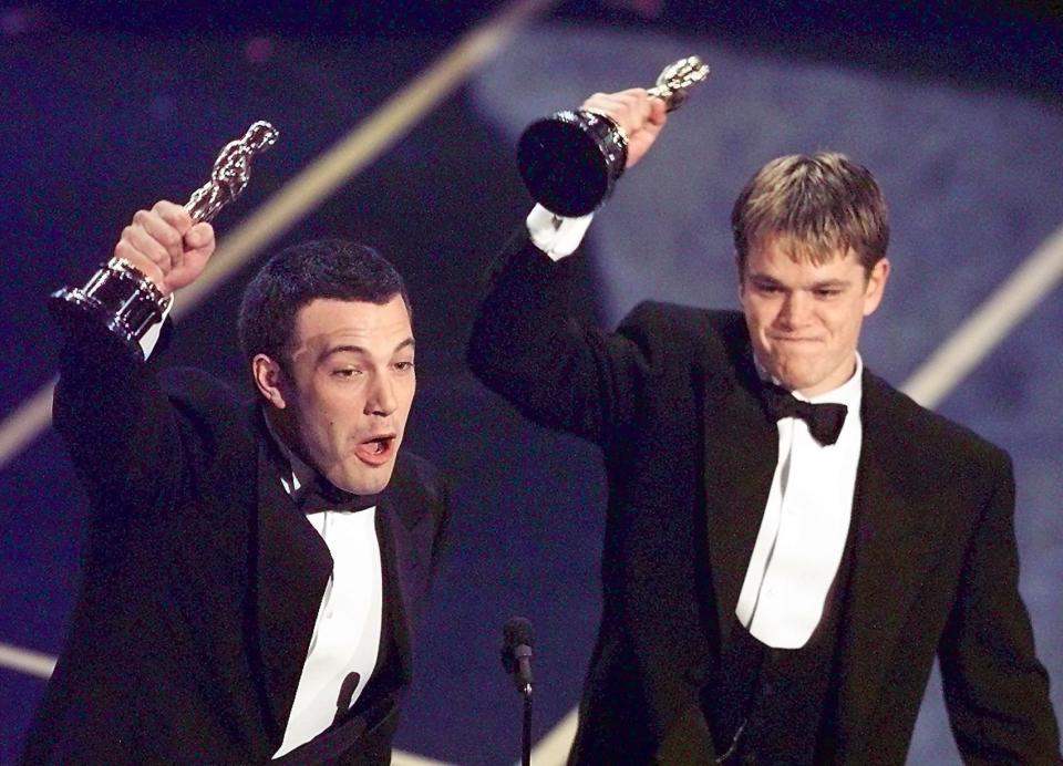 LOS ANGELES, UNITED STATES:  Ben Affleck (L) and Matt Damon hold up their Oscars after winning in the Original Screenplay  Category during the 70th Academy Awards at the Shrine Auditorium 23 March. The two won for their Original Screenplay 'Good Will Hunting.'    (ELECTRONIC IMAGE)   AFP PHOTO/Timothy A. Clary (Photo credit should read TIMOTHY A. CLARY/AFP/Getty Images)