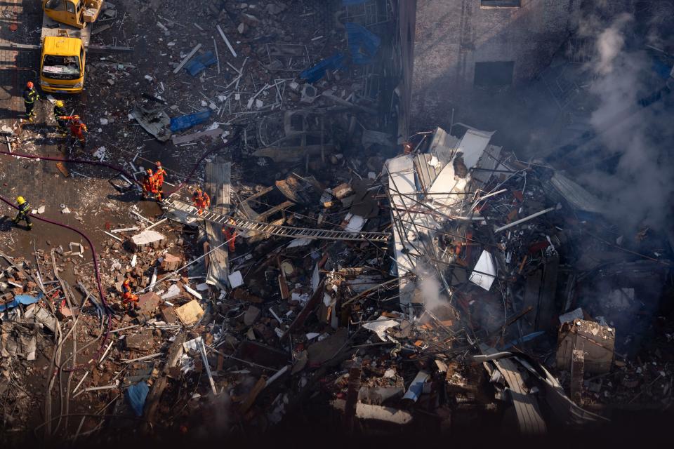 Firefighters work to clear debris in Yanjiao.