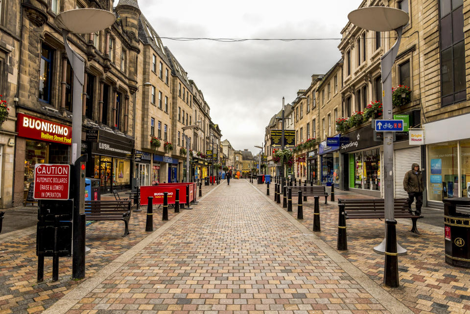 A popular for shopping and dining walking High Street in Inverness historical city centre, Scotland, October 2017