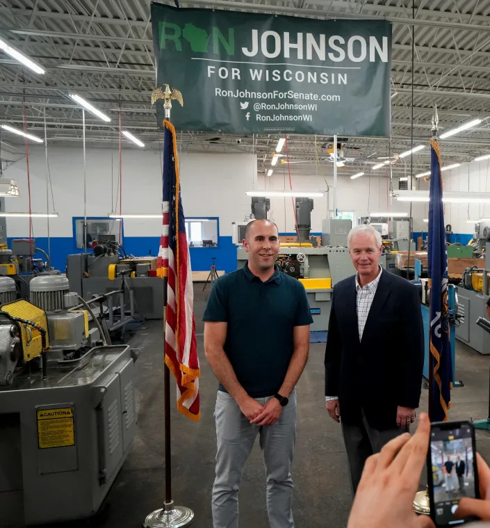 Sen. Ron Johnson takes photos with supporters at Rolled Threads Unlimited Friday in Waukesha after getting an endorsement from the National Federation of Independent Businesses.