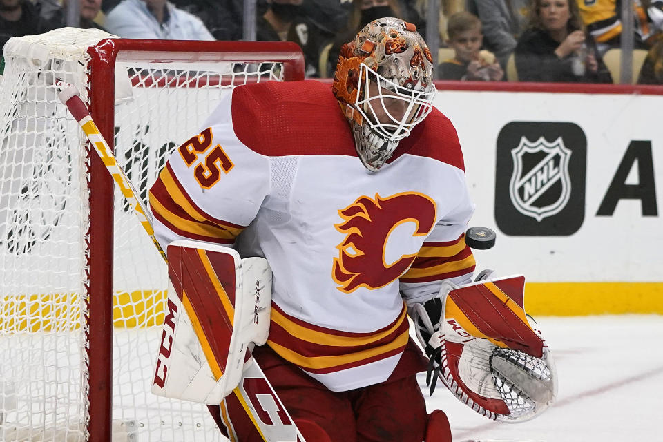 Calgary Flames goaltender Jacob Markstrom blocks a shot during the second period of the team's NHL hockey game against the Pittsburgh Penguins in Pittsburgh, Thursday, Oct. 28, 2021. (AP Photo/Gene J. Puskar)