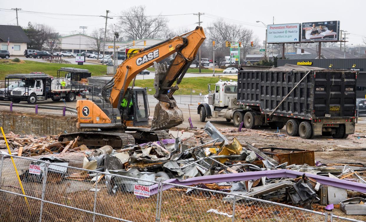 Rubble is scooped up Friday, Dec. 10, after the former Night Moves building on South Walnut Street was demolished to make way for an apartment complex.