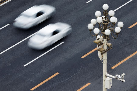 Cars drive on Chang'an Avenue near Tiananmen Square in Beijing, China April 9, 2019. REUTERS/Thomas Peter