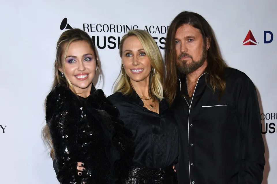 Miley Cyrus, Tish Cyrus, and Billy Ray Cyrus at the Recording Academy event, posing together in stylish black outfits on the red carpet