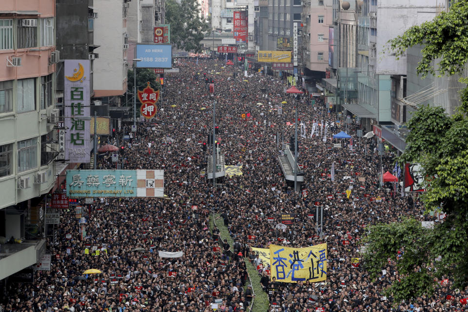 FILE - In this Sunday, June 16, 2019, file photo, tens of thousands of protesters march through the streets as they continue to protest against the unpopular extradition bill in Hong Kong. (AP Photo/Kin Cheung, File)