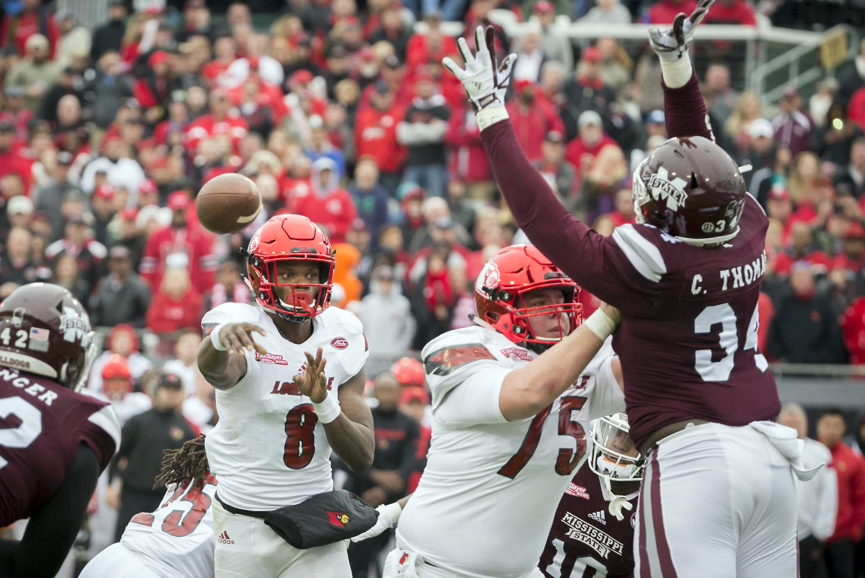 Louisville quarterback Lamar Jackson (8) throws a touch down pass to tight end Charles Standberry during the first half of the TaxSlayer Bowl NCAA college football game against Mississippi State, Saturday, Dec. 30, 2017, in Jacksonville, Fla. (AP Photo/Stephen B. Morton)