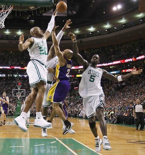 Derek Fisher lofts a shot over three Celtics to help the Lakers clinch a Game 3 victory over the Celtics during the 2010 NBA Finals.