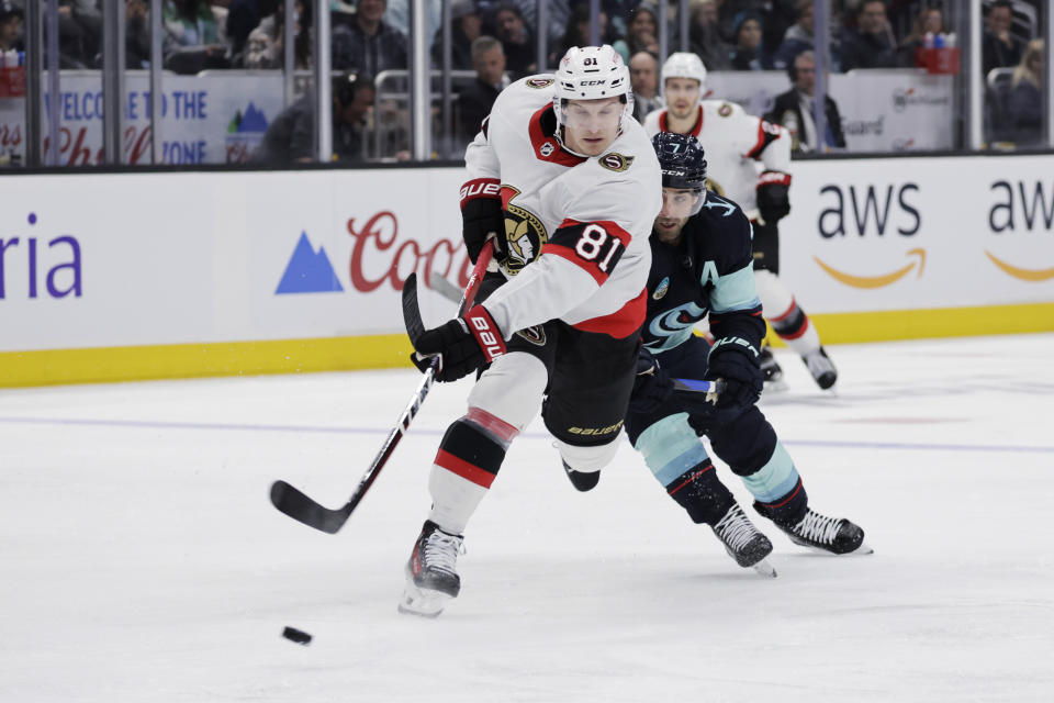 Ottawa Senators left wing Dominik Kubalik (81) shoots on goal but has it blocked with Seattle Kraken right wing Jordan Eberle (7) behind during the second period of an NHL hockey game, Thursday, Jan. 4, 2024, in Seattle. (AP Photo/John Froschauer)