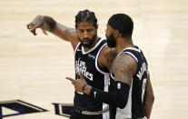 Los Angeles Clippers guard Paul George, left, celebrates with forward Marcus Morris Sr. during a timeout in the second half of Game 3 of a second-round NBA basketball playoff series against the Utah Jazz Saturday, June 12, 2021, in Los Angeles. (AP Photo/Mark J. Terrill)