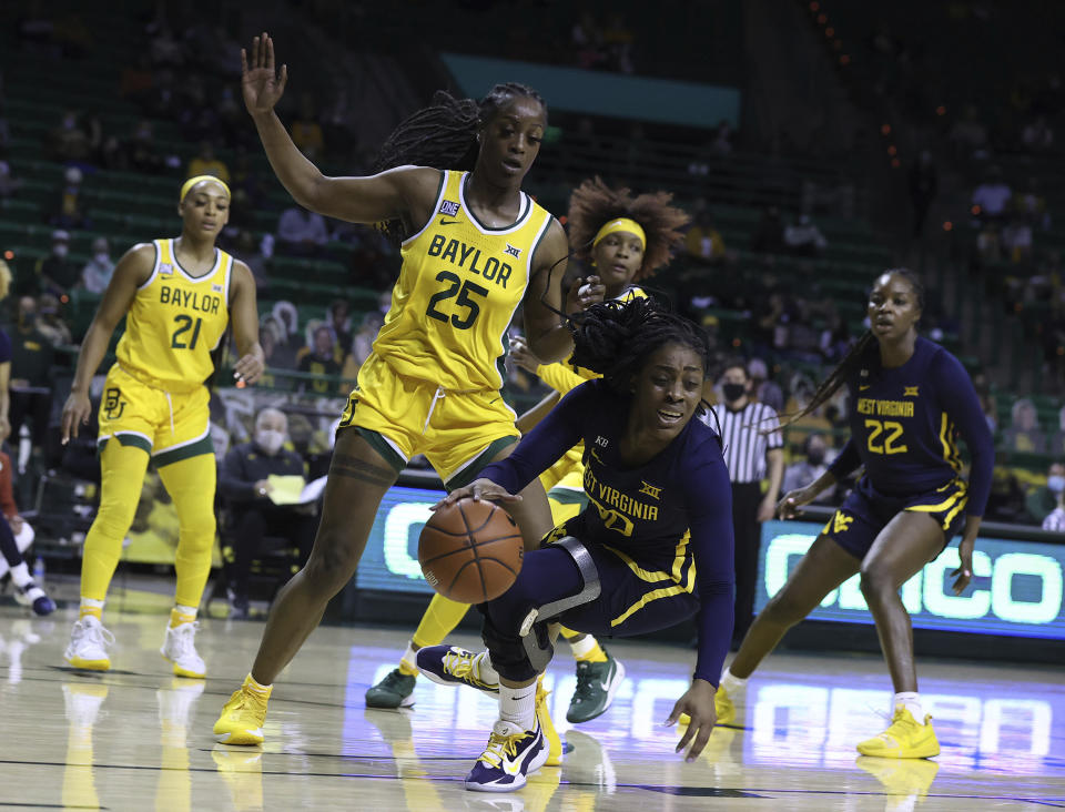 West Virginia guard Jayla Hemingway, front right, maintains her balance while driving on Baylor center Queen Egbo (25) in the first half of an NCAA college basketball game, Monday, March 8, 2021, in Waco, Texas. (Rod Aydelotte/Waco Tribune-Herald via AP)