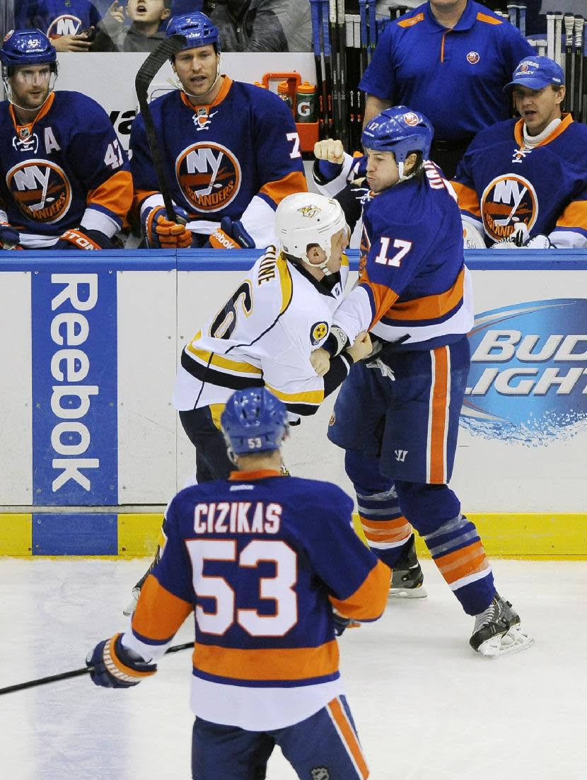New York Islanders' Matt Martin (17) and Nashville Predators' Richard Clune (16) battle during the first period of an NHL hockey game on Tuesday, Nov. 12, 2013, in Uniondale, N.Y. (AP Photo/Kathy Kmonicek)