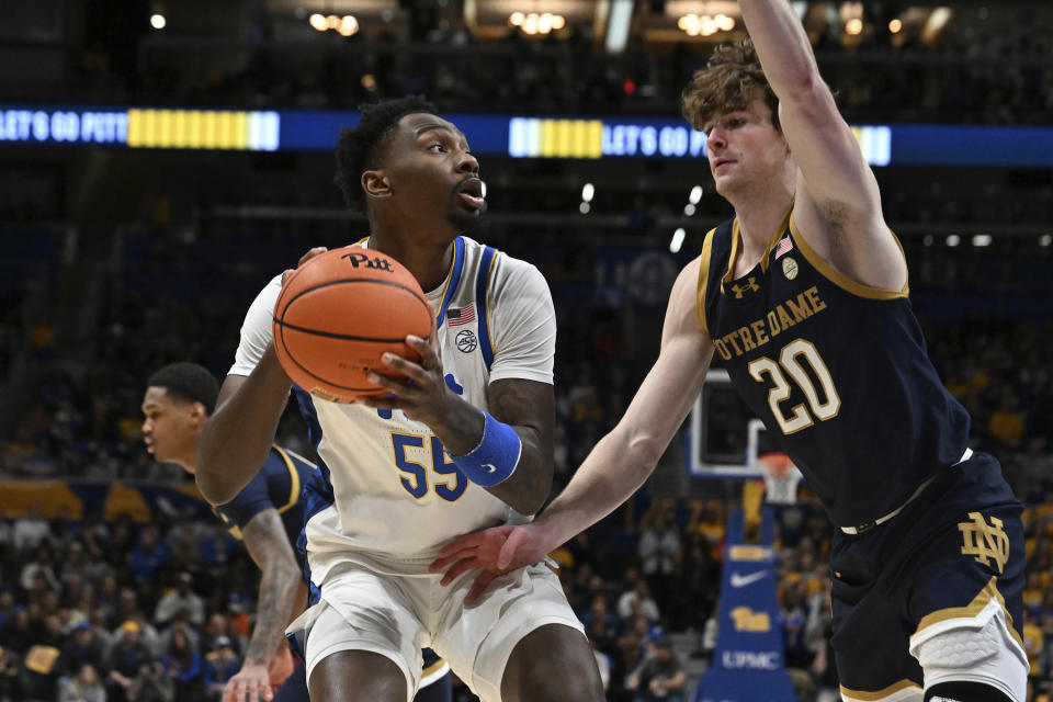 Pittsburgh forward Zack Austin (55) drives to the hoop as Notre Dame guard J.R. Konieczny (20) defends during the first half of an NCAA college basketball game, Saturday, Feb. 3, 2024, in Pittsburgh. (AP Photo/Barry Reeger)