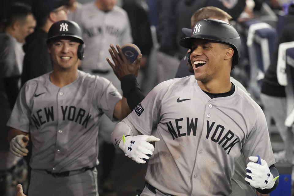 New York Yankees' Juan Soto celebrates in the dugout after hitting a three-run home run off Toronto Blue Jays pitcher Yusei Kikuchi during the sixth inning of a baseball game Friday, June 28, 2024, in Toronto. (Chris Young/The Canadian Press via AP)