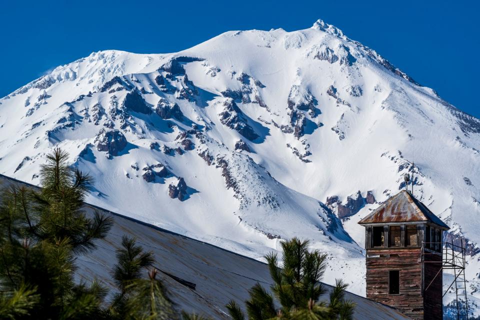 The watchtower of the McCloud Millworks is seen Monday, April 1, 2024 against the southeast face of California's Mt. Shasta.