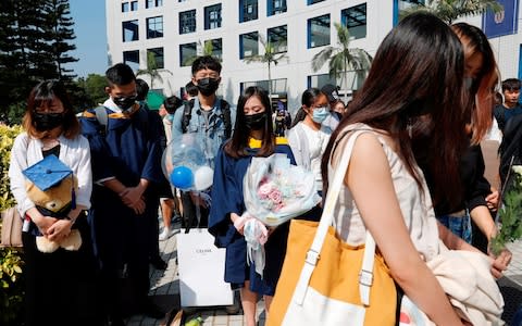 Graduates attend a ceremony to pay tribute to Mr Chow - Credit: REUTERS/Tyrone Siu