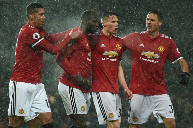 Manchester United's Romelu Lukaku (2nd L) celebrates with teammates after scoring during their English Premier League match against Bournemouth, at Old Trafford in Manchester, on December 13, 2017