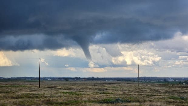 A tornado is shown spinning over Alberta on June 14, 2023. Researchers say the number of tornadoes fell from a record 129 in 2022 to just 86 in 2023 during the worst wildfire season ever in Canada. 