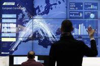 A staff member demonstrates cloud computing software to operate airlines, at the booth of Microsoft during preparations at the CeBit computer fair in Hanover, Germany March, 5, 2012.