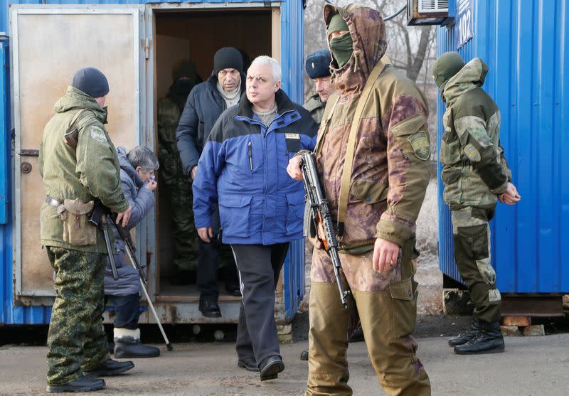 Men are escorted before prisoner of war exchange in Donetsk region