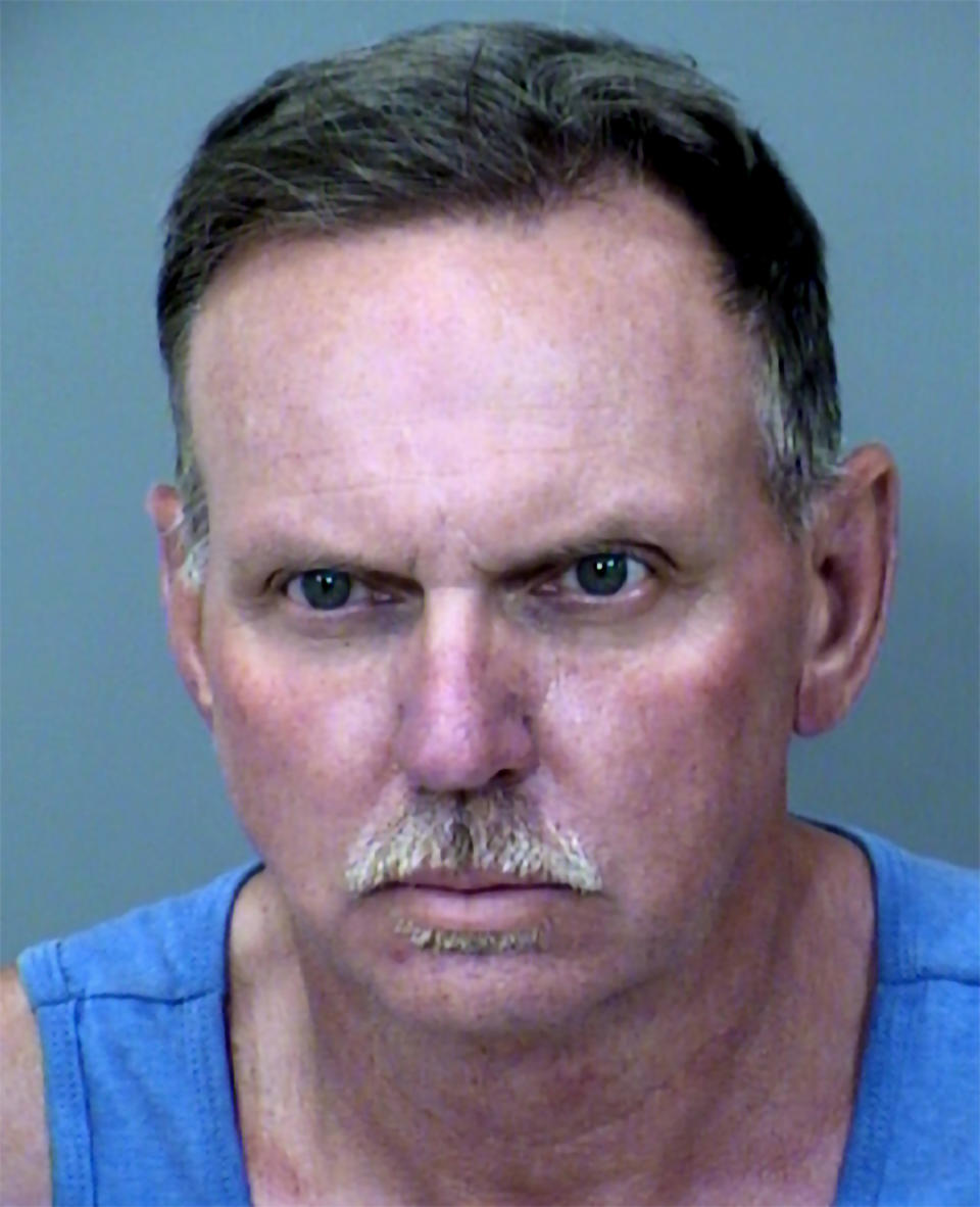 This undated booking photo provided by the Chandler Police shows Landon Earl Rankin, 54, who was arrested Wednesday, May 4, 2022, in two thefts of wedding gifts at private venues in April and was being held without bond, according to Chandler police and court and jail records. According to Chandler police, each of the two stolen wedding card boxes contained between $3,000 and $6,000. Rankin was a deputy for Pinal County Sheriff's Office who joined the agency in 1994, retired in 2015 but remained a reserve officer until 2017, office spokesperson Lauren Reimer said. (Chandler Police via AP)