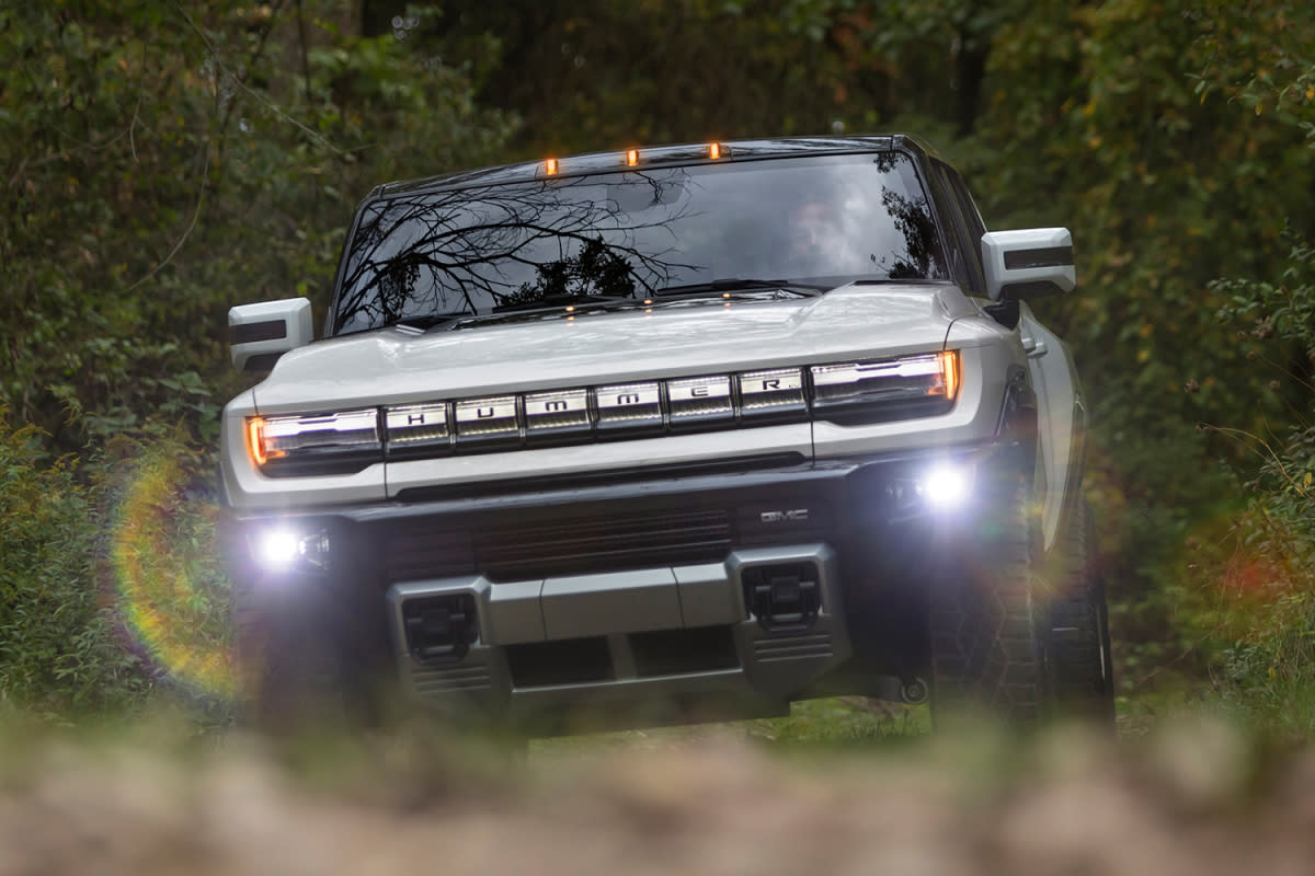 The GMC Hummer EV supertruck, a new electric pickup truck, driving through the dirt