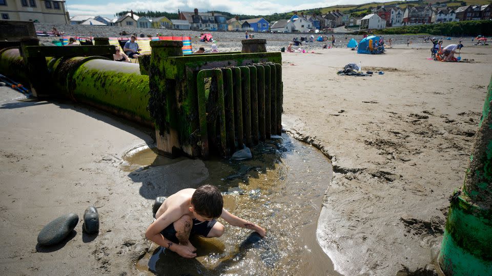 Storm overflows are a common sight on the UK's beaches. Here, a child is playing with the discharge from an overflow on Borth Beach, Wales. - Christopher Furlong/Getty Images