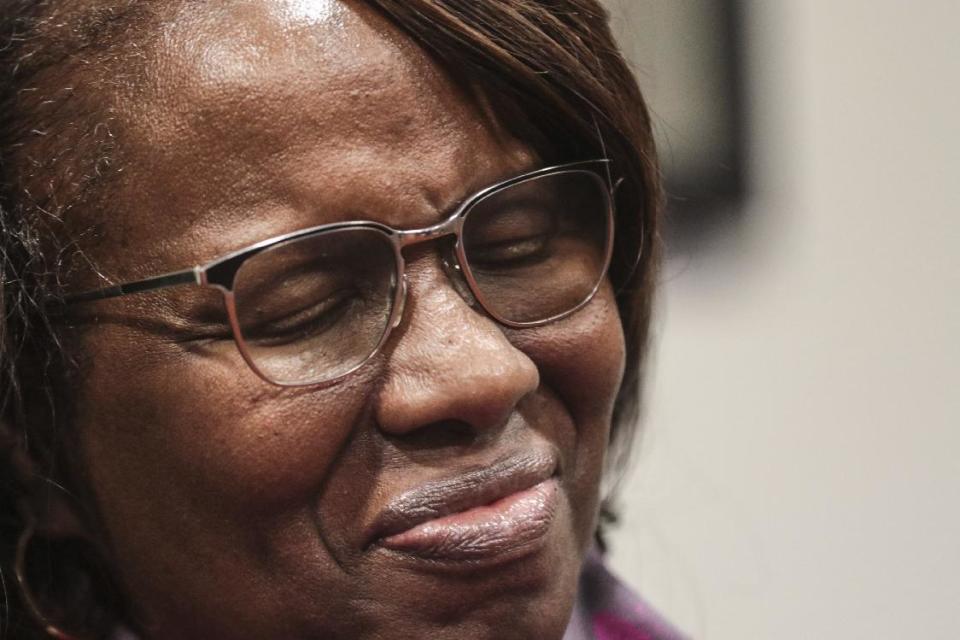 Felicia Sanders, who watched her son Tywanza Sanders die at the hands of Dylann Roof, smiles while speaking to media after Roof was found guilty of murdering nine parishioners at Emanuel AME Church in Charleston in a hate crime Friday, Dec. 15, 2016, in Charleston S.C. "I wear a smile now because the nine victims wore beautiful smiles in photos before they were killed," Sanders said. (Matt Walsh/The State via AP)