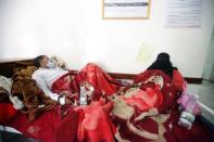A man and his wife infected with cholera lie on a bed at a hospital in Sanaa, Yemen May 12, 2017. REUTERS/Mohamed al-Sayaghi
